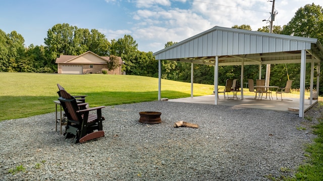 view of property's community with a patio, a fire pit, a gazebo, and a lawn