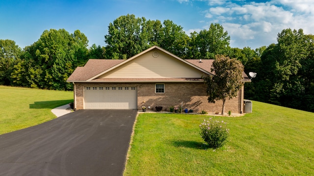 single story home featuring a front yard and a garage