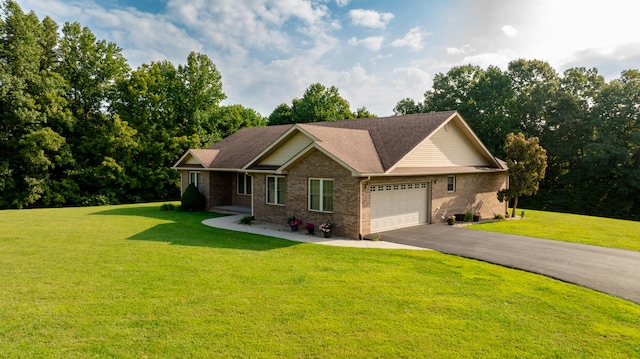 view of front of property with a front yard and a garage