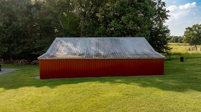 exterior space featuring an outbuilding and a lawn