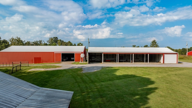 rear view of property with a yard and an outbuilding