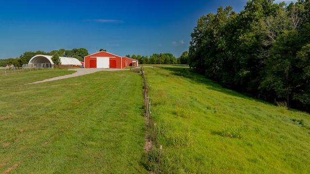 view of yard with a rural view and an outdoor structure