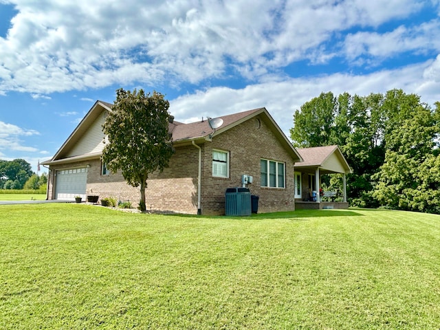 view of side of home with central AC, a garage, and a lawn