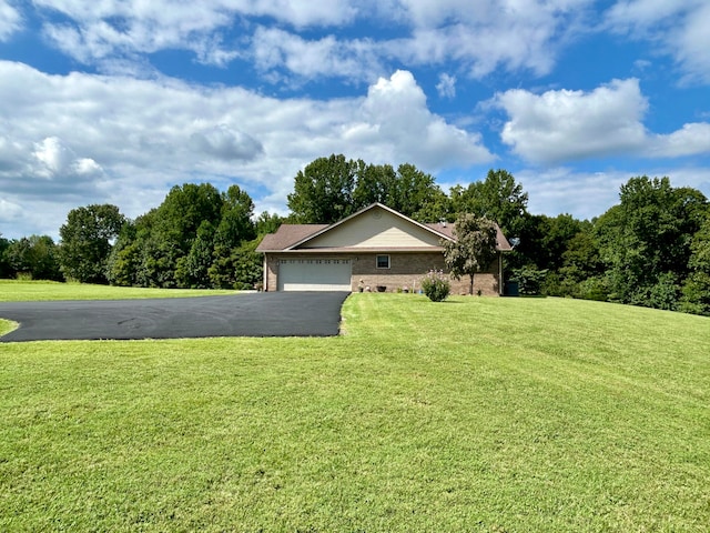 single story home featuring a garage and a front lawn