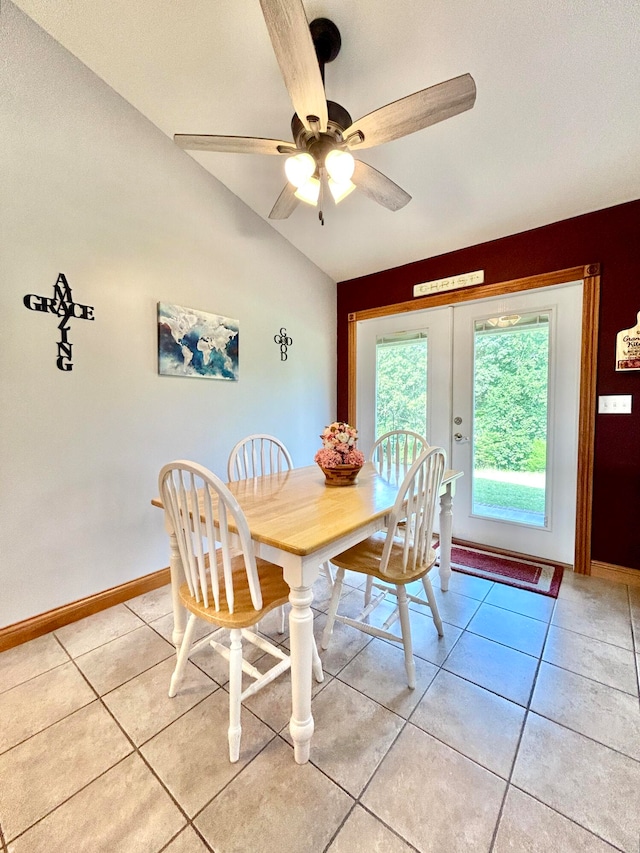 dining space featuring vaulted ceiling, ceiling fan, and light tile patterned floors