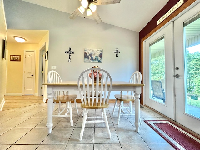 tiled dining room featuring french doors, ceiling fan, and lofted ceiling