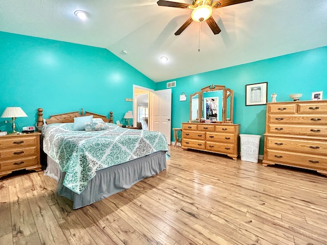 bedroom with light wood-type flooring, lofted ceiling, and ceiling fan