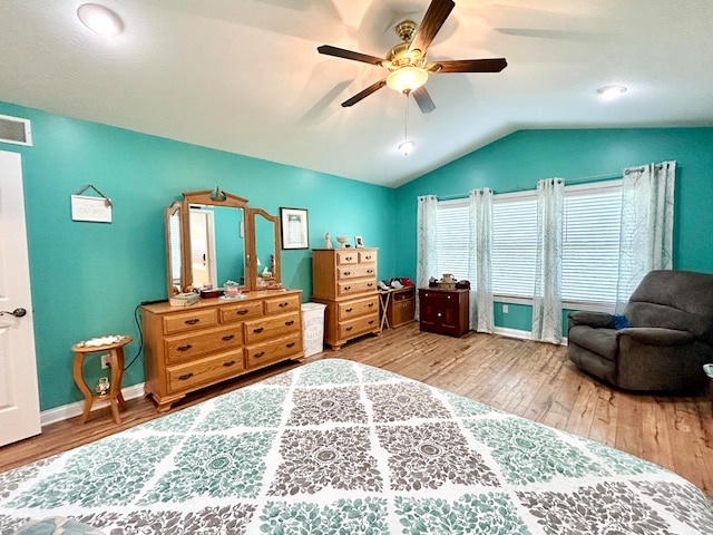 bedroom with ceiling fan, light hardwood / wood-style flooring, and lofted ceiling