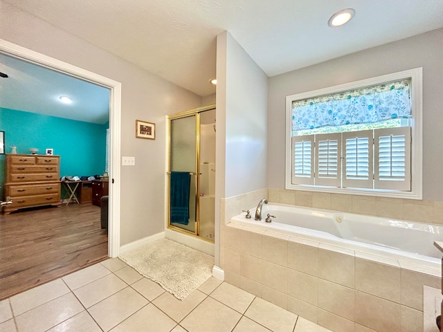 bathroom with tile patterned floors and plus walk in shower