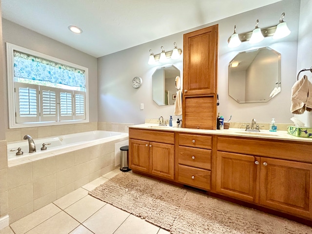 bathroom with vanity, tiled tub, and tile patterned floors