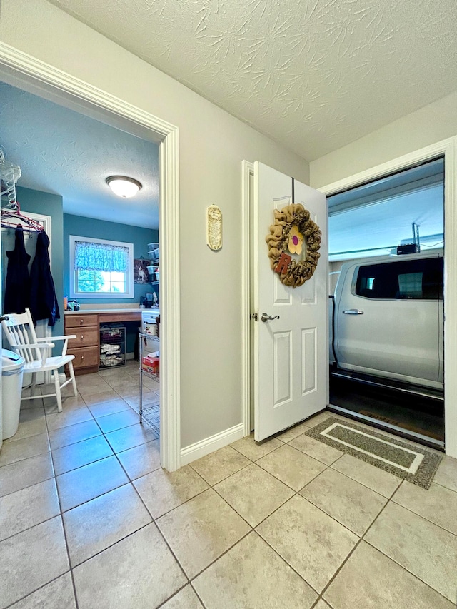 interior space with a textured ceiling and beverage cooler