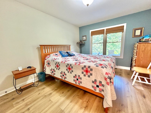 bedroom with wood-type flooring