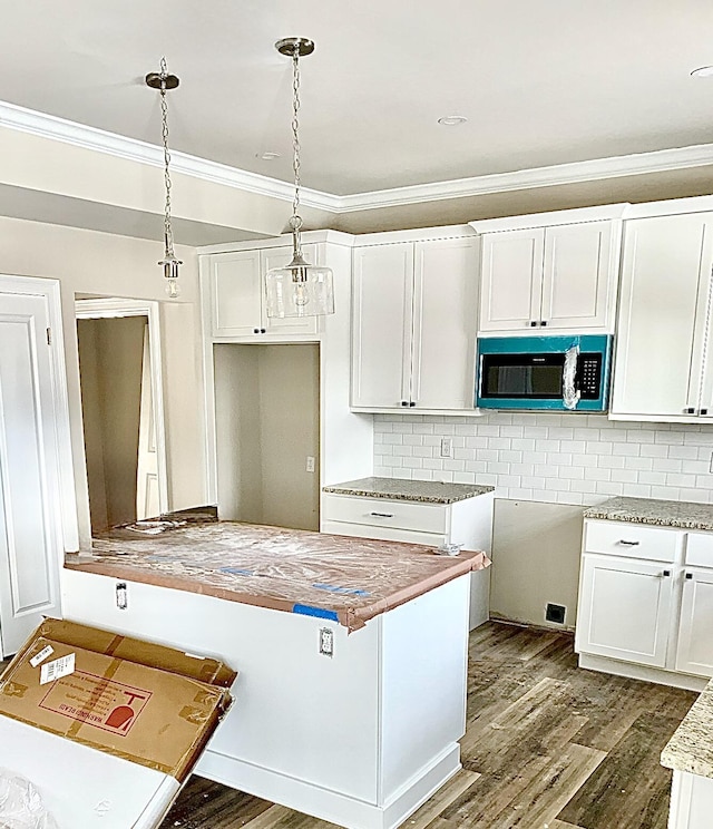 kitchen with decorative backsplash, decorative light fixtures, dark hardwood / wood-style flooring, ornamental molding, and white cabinets