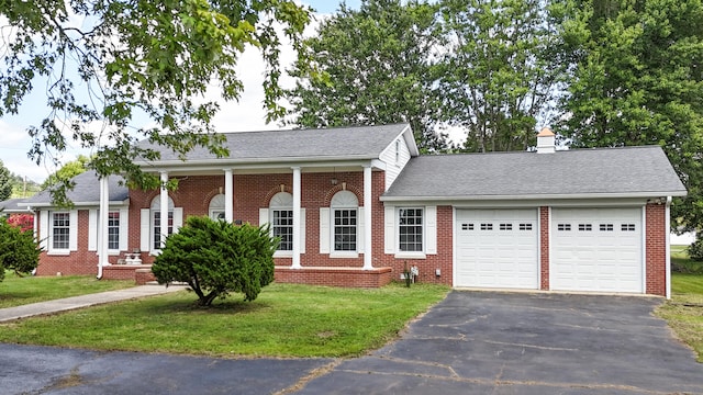 view of front of property with a garage and a front lawn