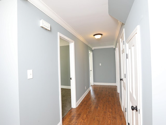 corridor with dark wood-type flooring and ornamental molding