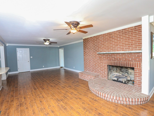 unfurnished living room with hardwood / wood-style floors, crown molding, ceiling fan, and a brick fireplace