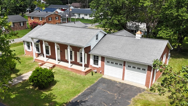 view of front of house with a garage and a front lawn