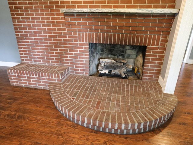 details featuring wood-type flooring and a brick fireplace