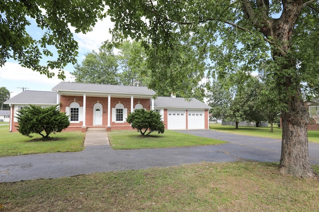 view of front facade with covered porch, a garage, and a front lawn