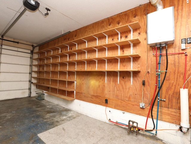 garage featuring wood walls and a garage door opener