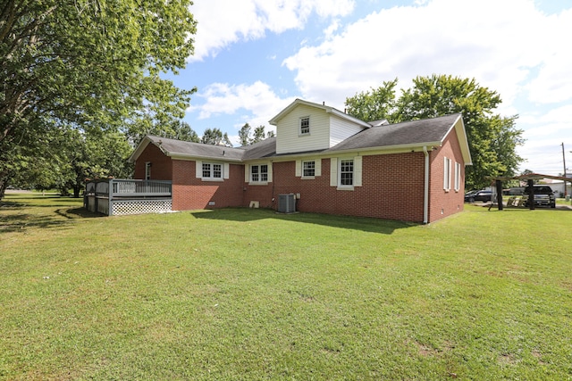 rear view of house featuring central air condition unit, a yard, and a deck