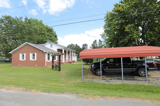 exterior space featuring a front lawn and a carport