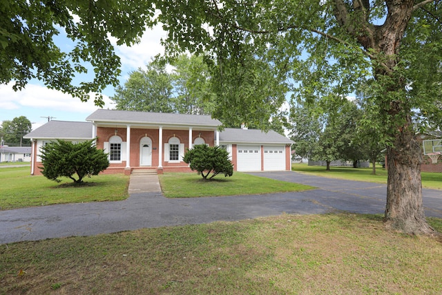 view of front of house with a garage and a front yard