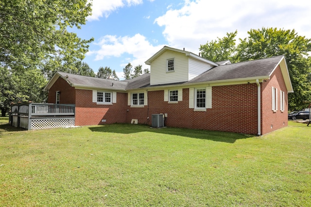 back of property with central air condition unit, a deck, and a lawn