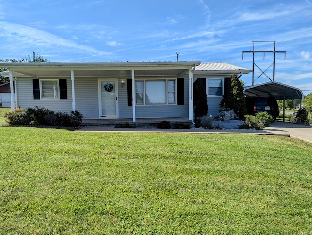 view of front of house with a front lawn, covered porch, and a carport