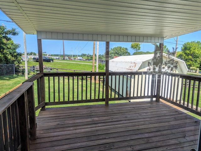 wooden deck featuring a yard and a storage shed