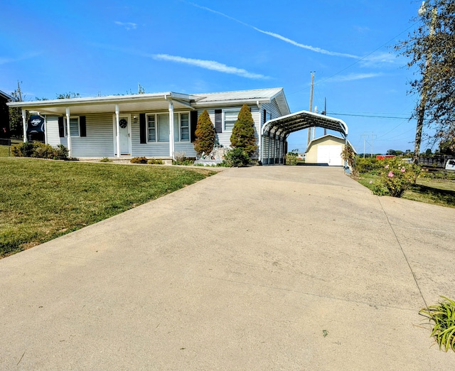 ranch-style house with covered porch, a garage, a front yard, and a carport