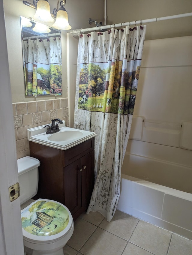 full bathroom with shower / bath combo with shower curtain, tile patterned flooring, vanity, and toilet