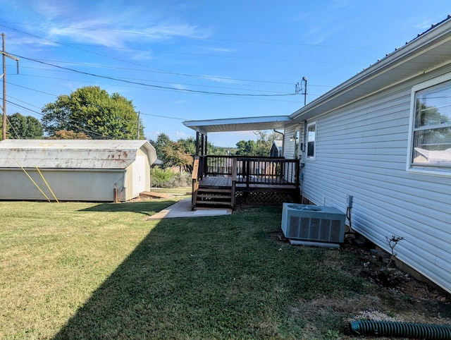 view of yard with a storage unit, central AC, and a wooden deck