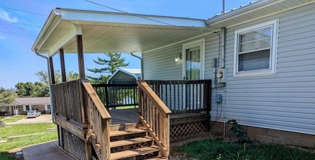 wooden terrace featuring a yard