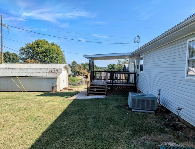 view of yard with cooling unit, a shed, and a deck