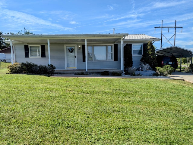 ranch-style home with covered porch, a front yard, and a carport