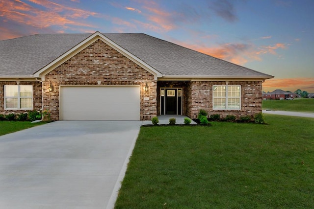 view of front facade with a lawn and a garage