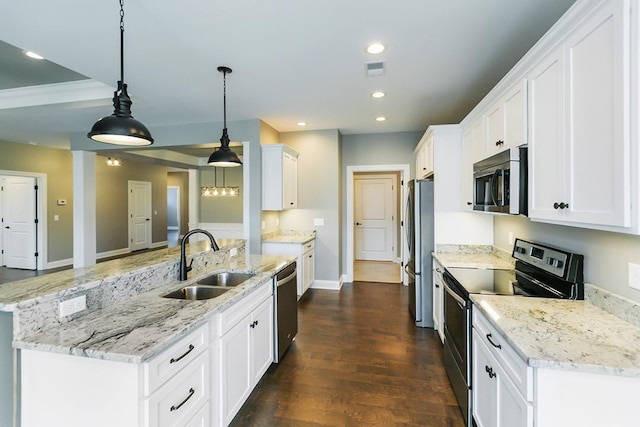 kitchen with sink, light stone counters, dark hardwood / wood-style floors, stainless steel appliances, and pendant lighting