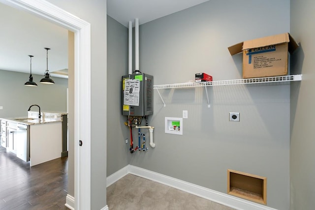 laundry area featuring sink, water heater, wood-type flooring, hookup for an electric dryer, and hookup for a washing machine