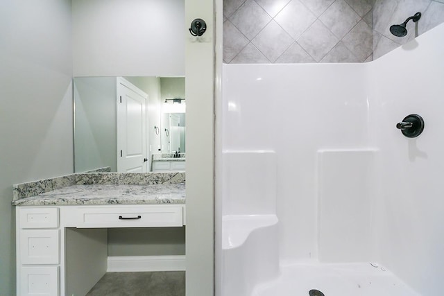 bathroom featuring a shower, tile patterned flooring, and vanity