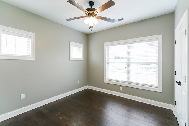 empty room with ceiling fan and dark wood-type flooring