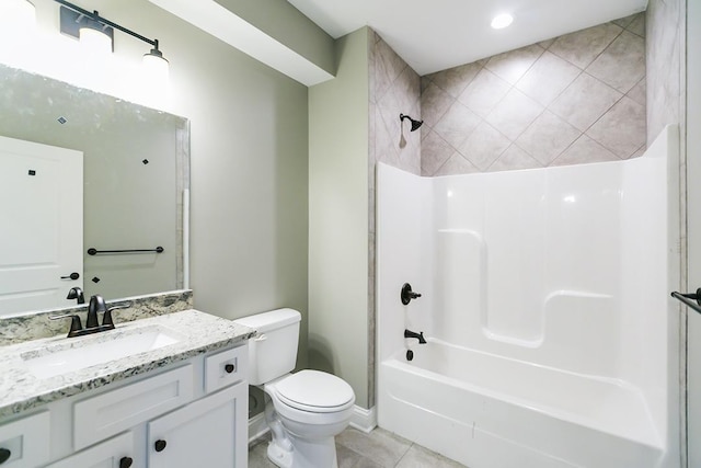 full bathroom featuring tile patterned flooring, toilet, vanity, and tiled shower / bath