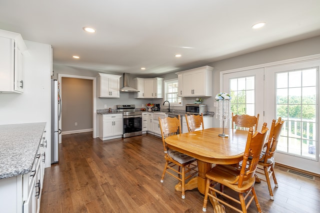 dining area featuring sink and dark hardwood / wood-style flooring