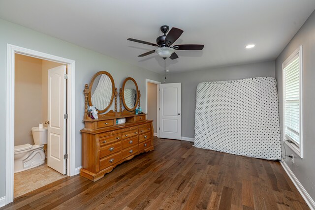 bedroom with ceiling fan, hardwood / wood-style floors, and ensuite bath