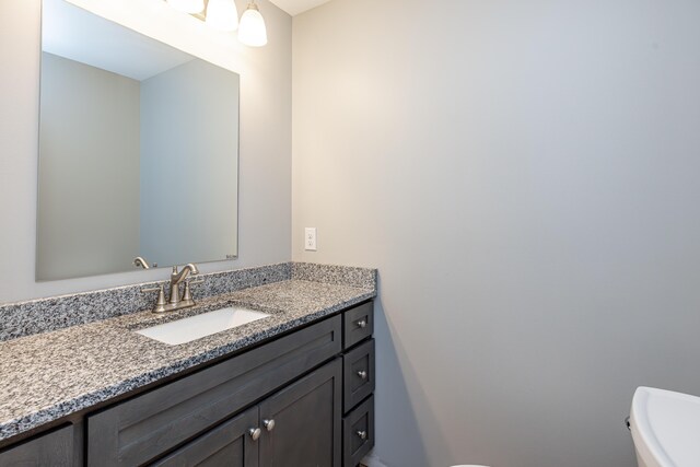 bathroom featuring toilet and vanity