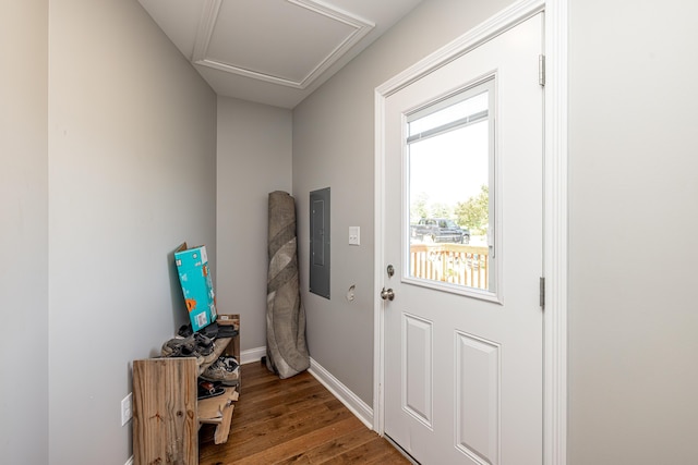 doorway to outside featuring electric panel, baseboards, and wood finished floors