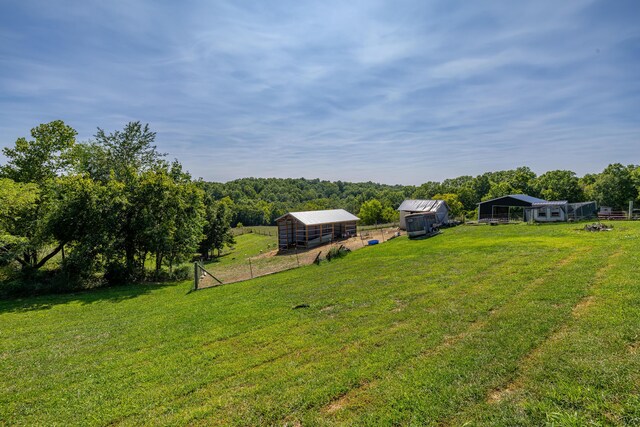 view of yard featuring a rural view and an outbuilding