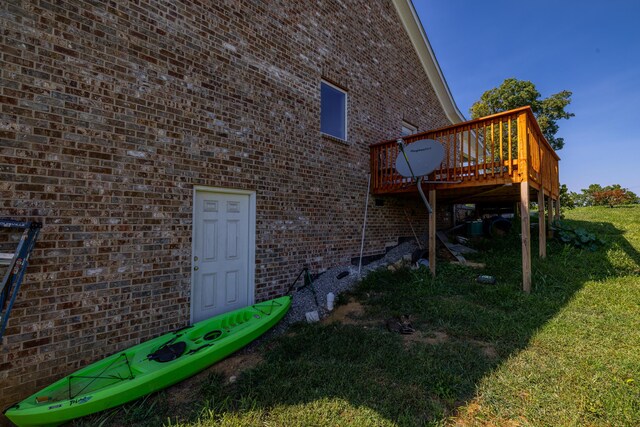 exterior space featuring a deck and a lawn