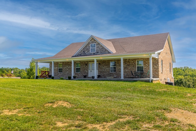 view of front of house with a front lawn and central air condition unit