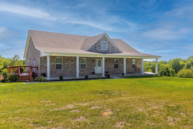 view of front of home with brick siding, roof with shingles, and a front yard